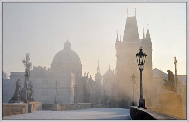 Charles Bridge in morning mist on a frosty dawn